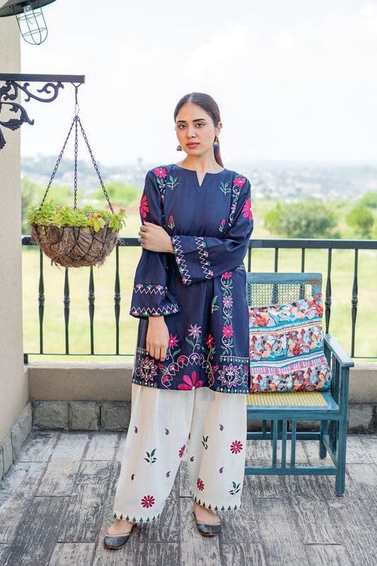 Fully embroidered two-piece lawn suit by Shaa Posh, showcasing intricate embroidery and vibrant fabric in a detailed close-up image.